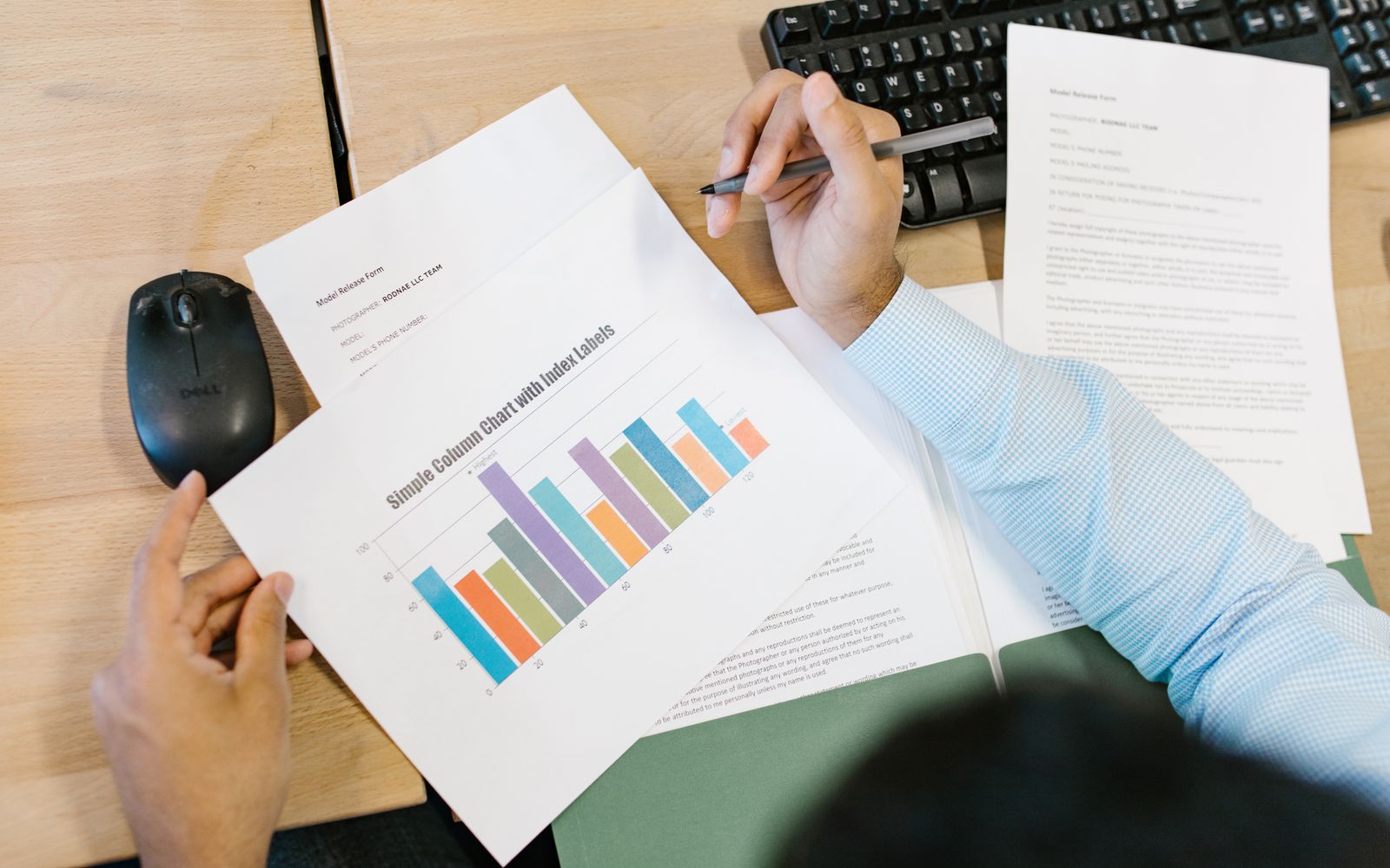 Analyst reviewing charts and documents at a desk